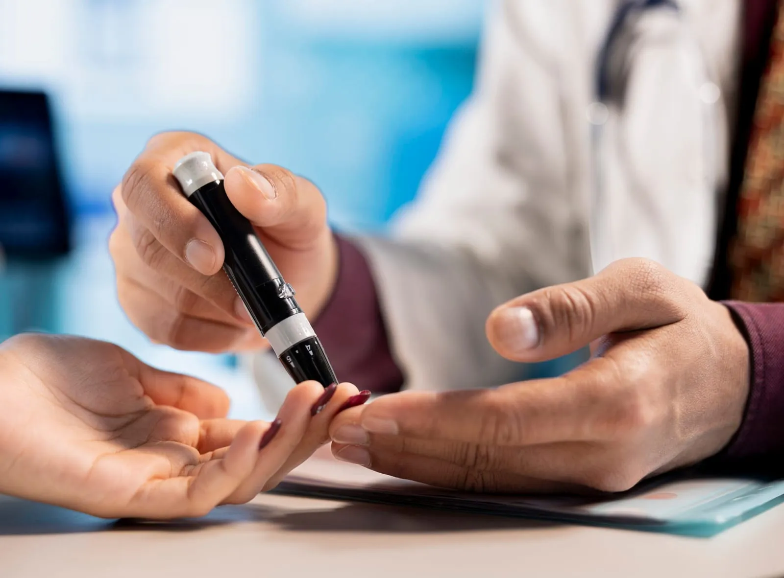 A healthcare professional showing a patient how to use an insulin pen