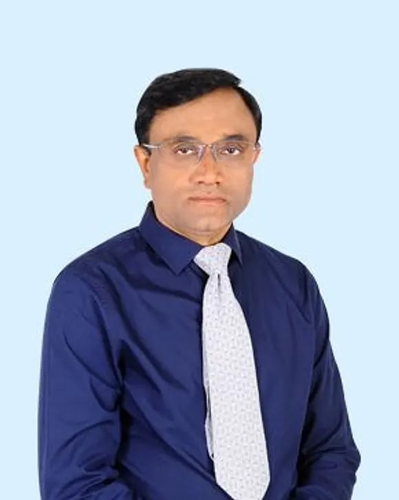 Portrait of Dr. Anil Srivastava, Senior Internal Medicine Specialist, in a blue shirt and tie